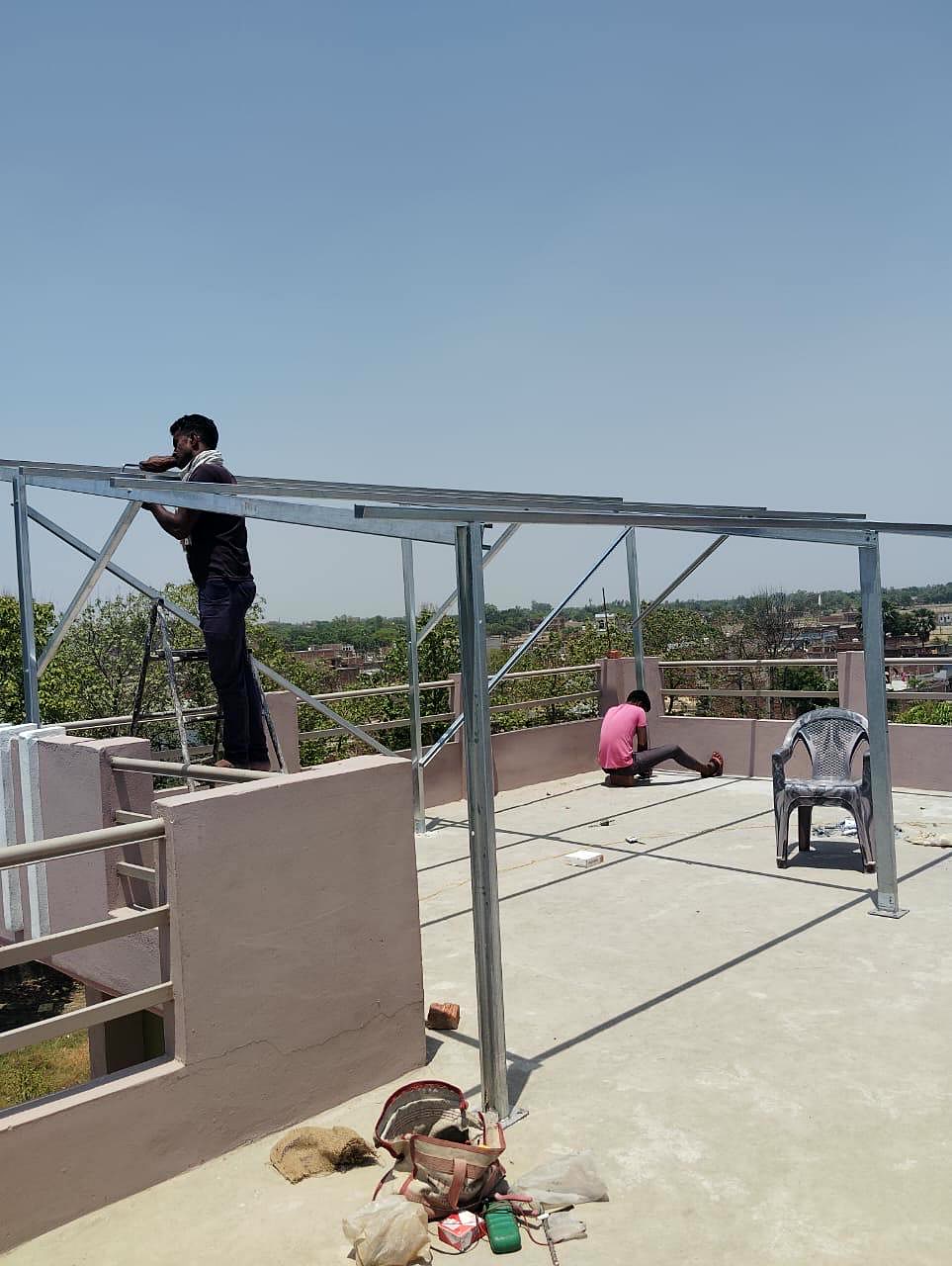 Custom-fabricated steel mounting structure being assembled by technicians